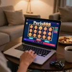 Engaging with Paris888 online slots while preparing to spin the reels in a cozy home setting